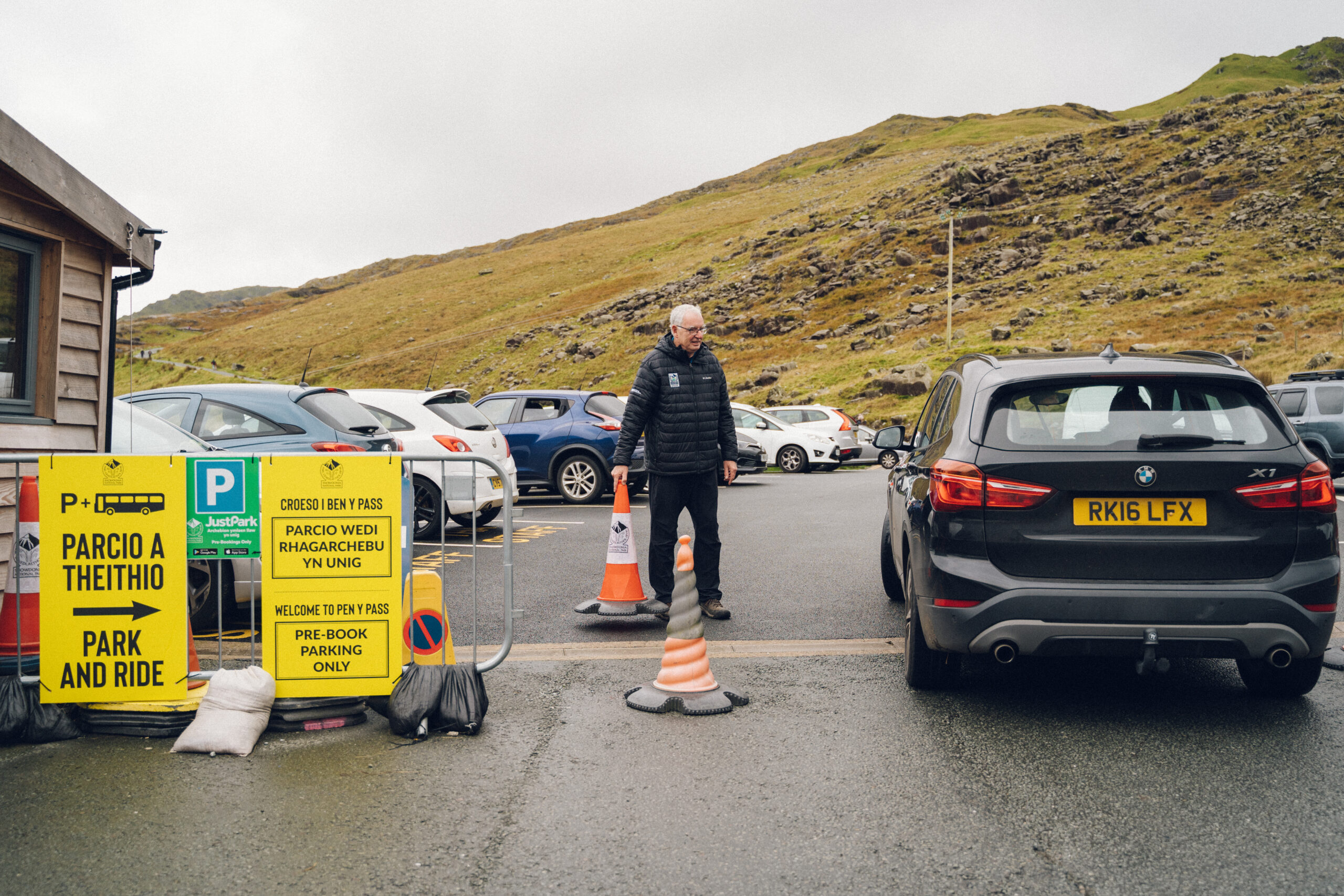An image of a National Park traffic warden at the car park in Pen y Pass